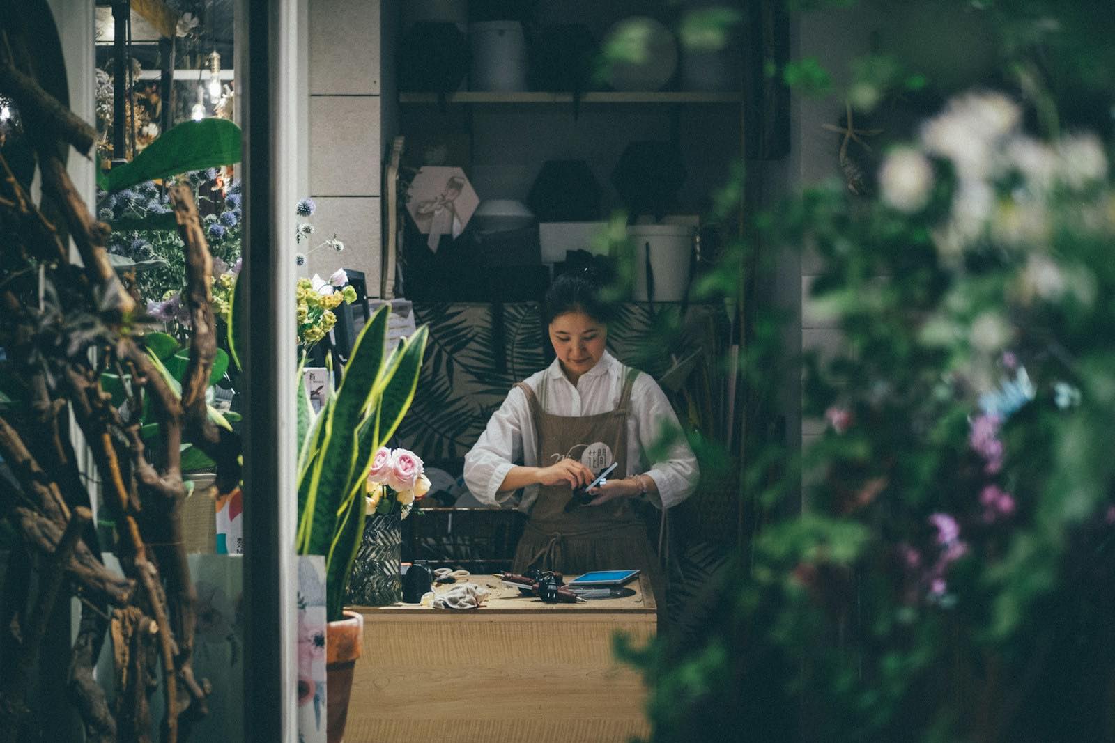A florist at a table of cut flowers
